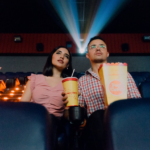 2 women sitting on blue leather chair holding white and red plastic cups — Foto por Felipe Bustillo na Unsplash