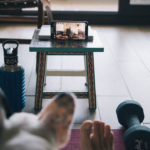person in white pants sitting on blue and white striped couch — Foto por Maria Jesus Errazuriz na Unsplash
